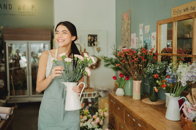 A happy female flower shop attendant.