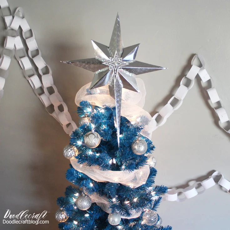 Silver Bells and Blue Christmas mash-up tree--bright blue tree with clear lights adorned with silver and white sparkly decorations
