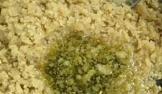Pouring sugar syrup into moong Dal halwa recipe