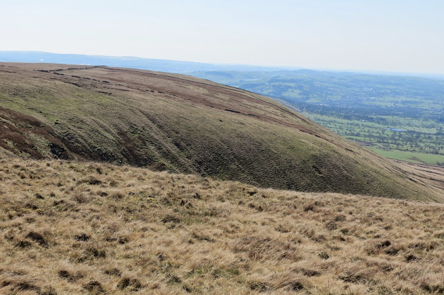 A view across the side of the hill, revealing a deep fold in the land.