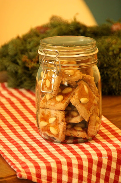 Spicy Gingerbread in a glass storage container on a red and white checkered kitchen towel