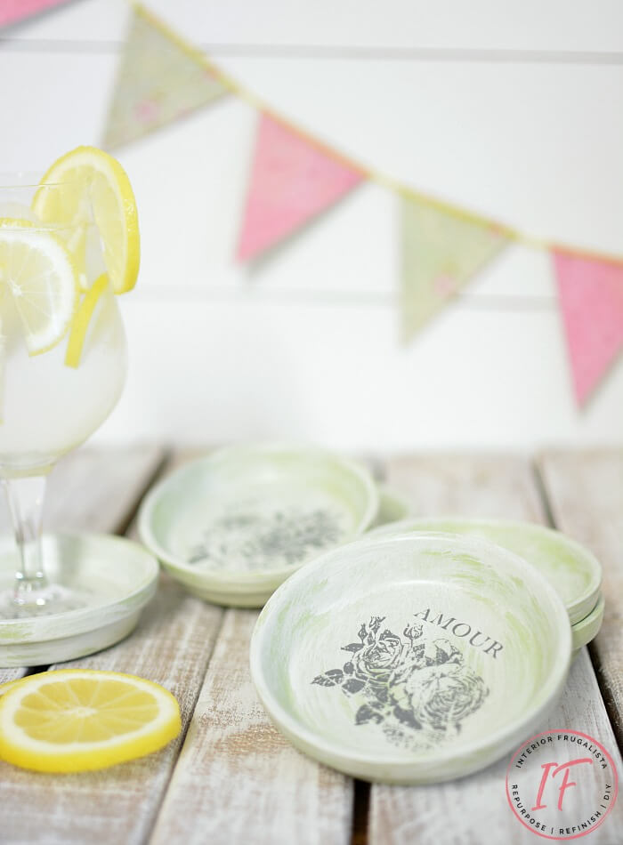 How to repurpose dollar store terracotta flower pot saucers into pretty summer drink coasters with French Country style using floral decor transfers.