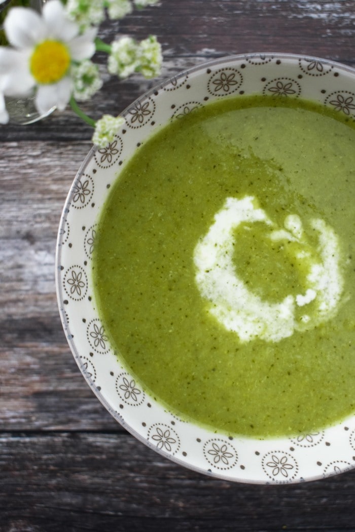 Broccoli and pea soup with a swirl of vegan cream