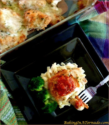 Baked Crispy Chicken Parmesan is full of classic Italian flavors, baked to a crispy crunch, topped with gooey melted cheese and served with marinara sauce. | Recipe developed by www.BakingInATornado.com | #recipe #chicken #dinner