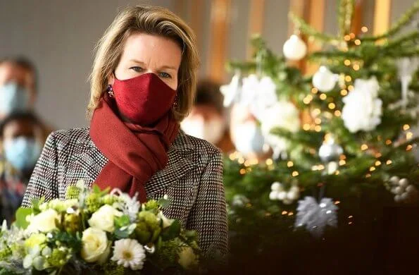 The Queen Elisabeth Music Chapel. Queen Mathilde wore a checked print long coat from Natan, and burgundy mask from Natan, Armani silk blouse