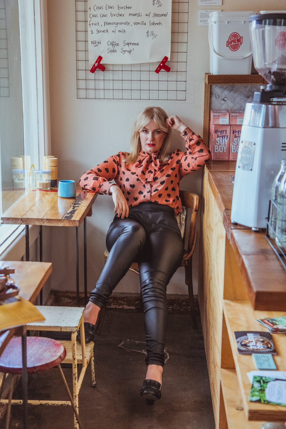 Liana of @findingfemme in black leather pants and pussy bow shirt