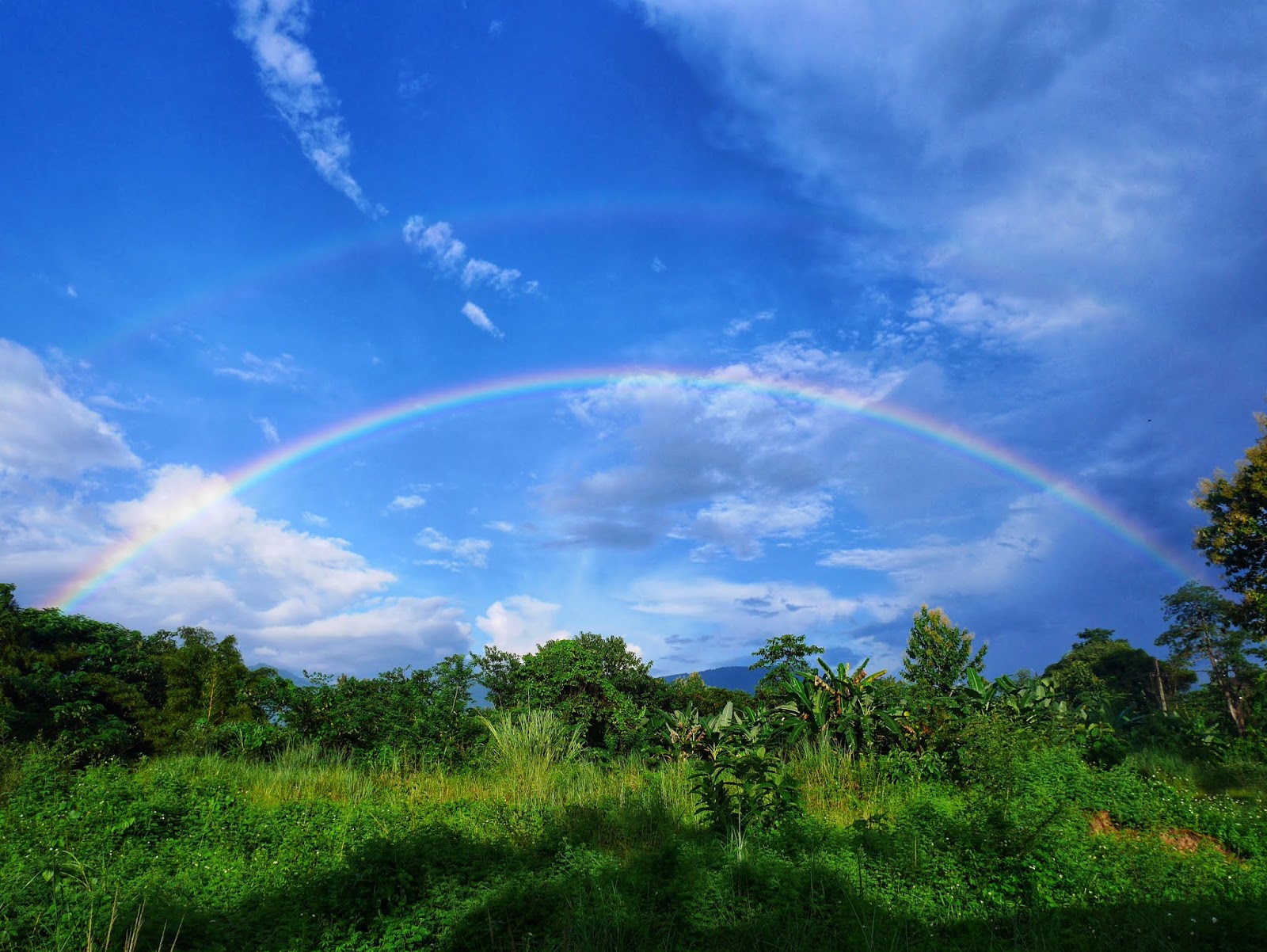 rainbow a double rainbow over the jungle in Vang Vieng, Laos