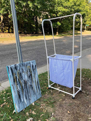 Abstract painting and laundry-sorting cart