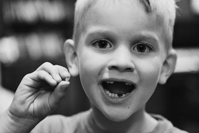 'Little dude' with his latest loose tooth from http://www.vintonville.com/little-dude/toothless/ 