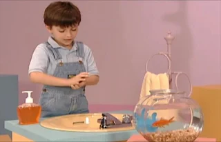 a child turns on the faucet and checks the temperature of the water before washing his hands. Sesame Street Elmo's World Hands Kids and Baby