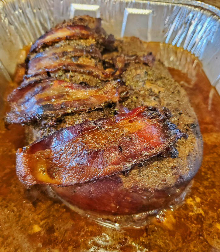 this is a delicious smoked venison tenderloin wrapped in bacon cooked in beer in a tin foil roasting pan