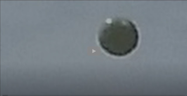 Snapshot from the video showing what can only be described as a spectacular silver UFO sphere.