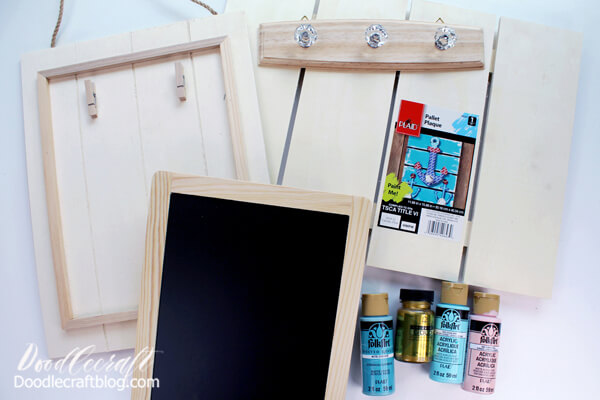 Supplies Needed for DIY Command Center: Chalkboard  Hanger with crystal knobs  Wood Pallet Plaque  Pallet Sign with Clips Folk Art Acrylic Paint (Cascade, Conch Shell and Ocean View) Treasure Gold Paint (Gold) Paintbrushes 1x2 board 21 inches long 1x1 boards 5 inches long (3) Small nails and Hammer Leather Strip (or ribbon could be used) Hook and Loop Closure Adhesive Strip Screwdriver Painters Tape Clean Soup Can Hot Glue/Gun E6000 Glue