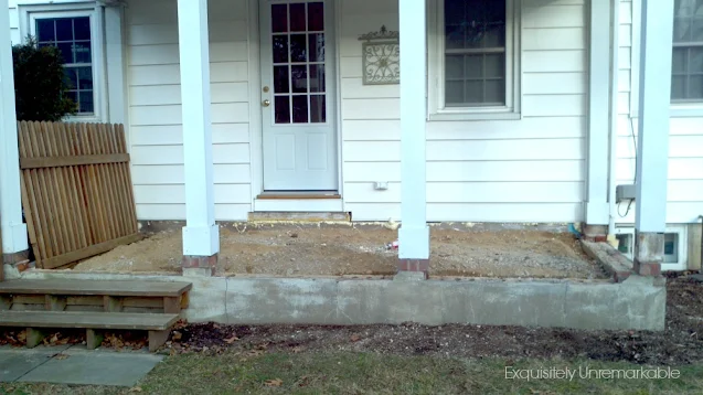 Covered porch in disarray with dirt floor