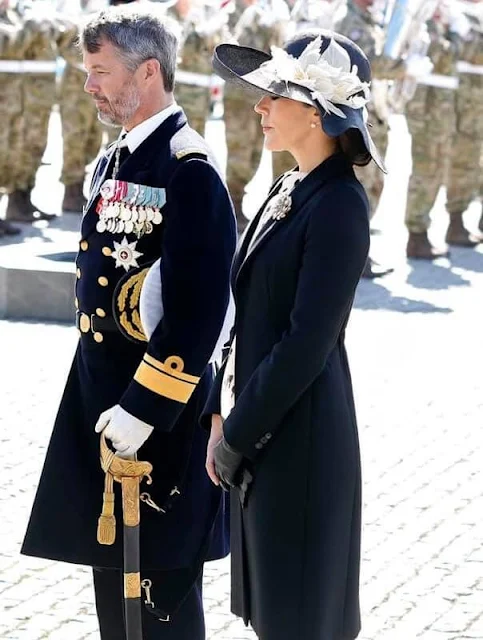 Crown Princess Mary wore a cappotto black coat by Prada, and printed silk dress by MaxMara. Jimmy Choo Billie pumps
