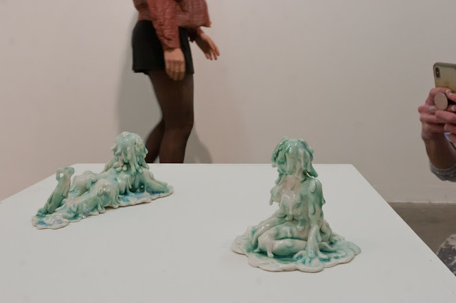 Image of two 'slime girls' on a plinth at knee height
