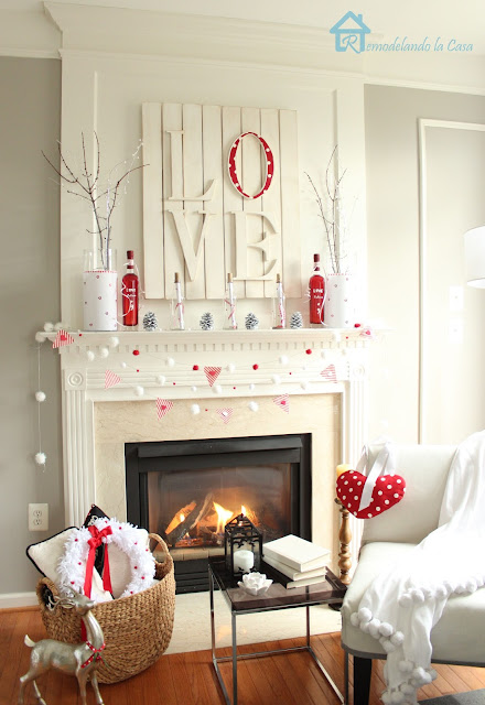 Valentine mantel with branches, love art and pom pom garland