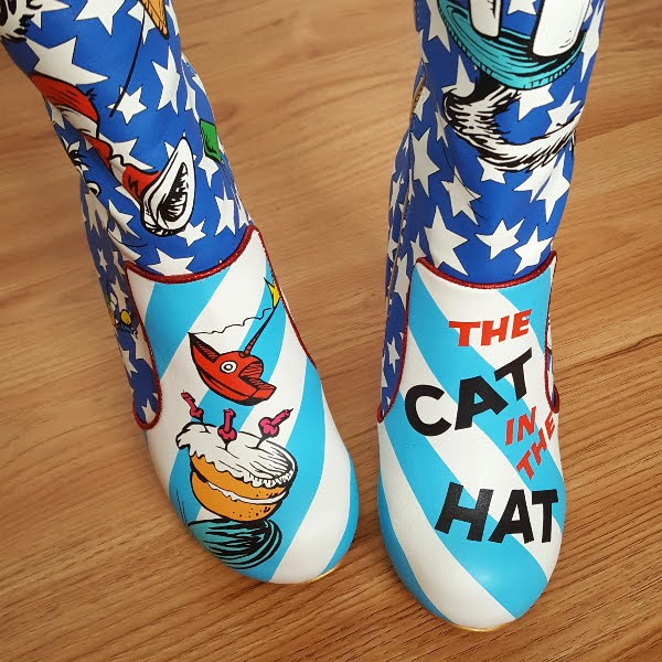 close up of striped toe of boots with cat in the hat and birthday cake illustration