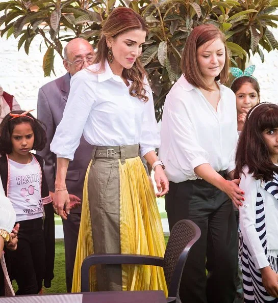 Queen Rania wore Sacai pleated midi skirt, Maison Makarem balloon shirt, Dior pumps and she carried Marni Trunk shoulder bag