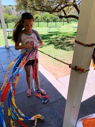 Emirates Singakwenza Waste 2 Toys workshop Girl plaiting a skipping rope