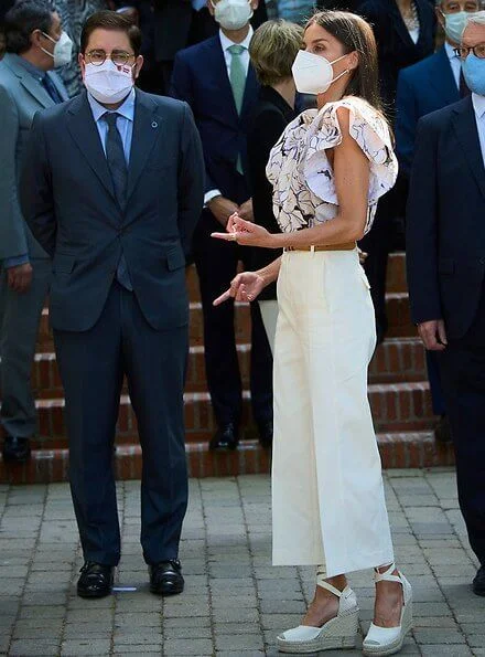 Queen Letizia wore a new double sleeve ruffle top from Psophia, and white suede espadrille wedges from Macarena, and Castaner wedges