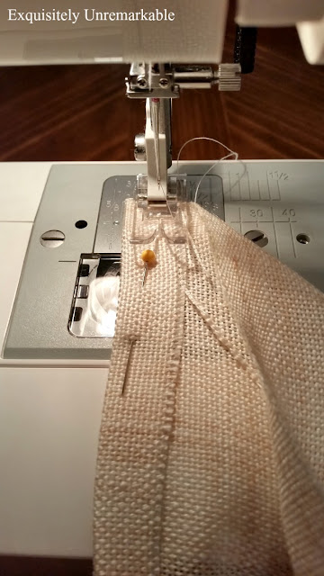 Linen material going through sewing machine