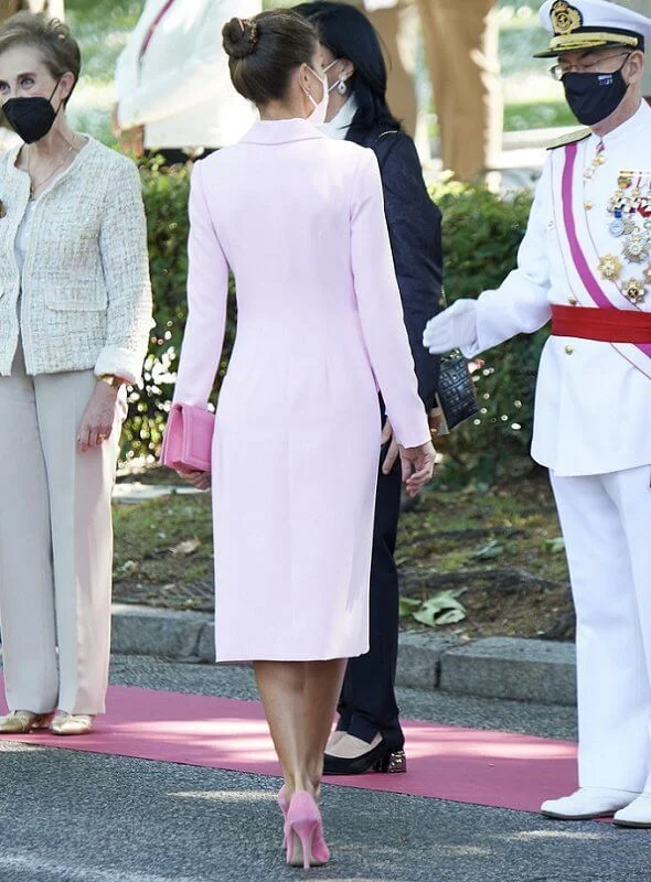 Queen Letizia wore a pink double breasted flared blazer dress coat, and pink clutch and pumps by Magrit. Tous jewelry earrings