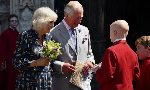 Charles wearing a crisp grey suit and Camilla wore her favourite dress by Fiona Clare