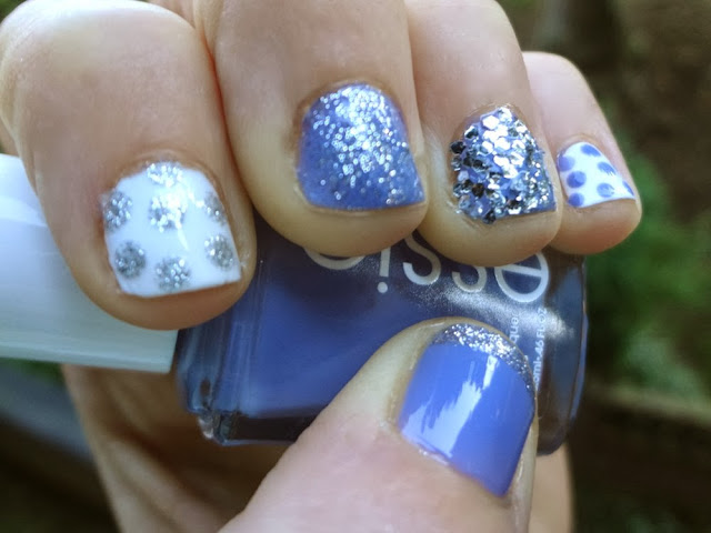 Blue nail polish with silver glitter, white polish with polka dots