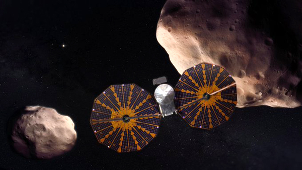 An artist's concept of NASA's Lucy spacecraft venturing past the Trojan asteroid Patroclus and its binary companion Menoetius near Jupiter's orbit. An artist's concept of NASA's Lucy spacecraft venturing past the Trojan asteroid Patroclus and its binary companion Menoetius near Jupiter's orbit.