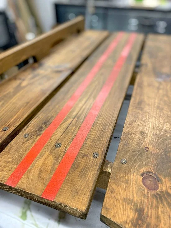 red painted lines on a wooden sled