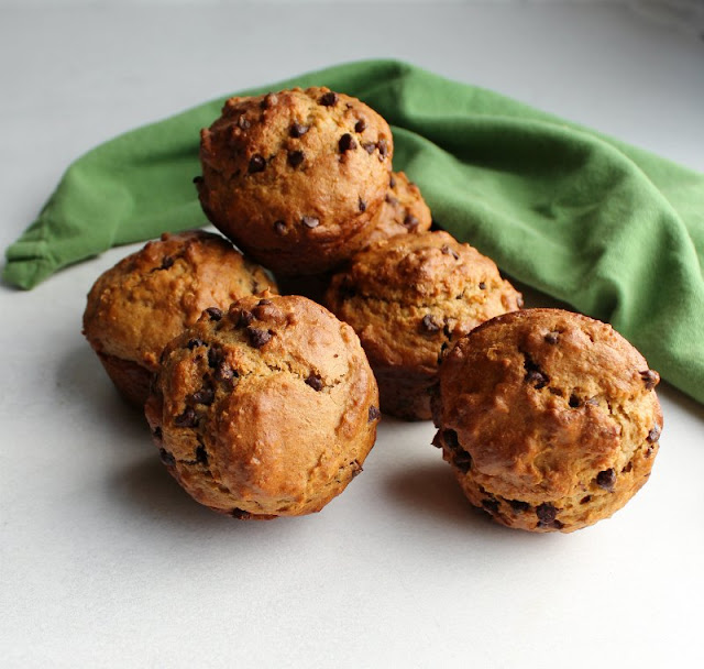 These chocolate chip sourdough muffins are a delicious and nutritious way to start your day! They are quick, easy and full of oatmeal and whole wheat goodness yet they are soft and yummy. So good! pile of chocolate chip oatmeal sourdough muffins ready to be eaten