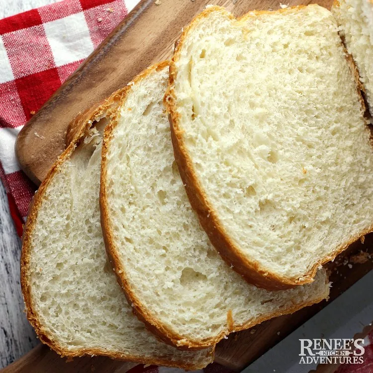 Bread slices on wooden board with knife