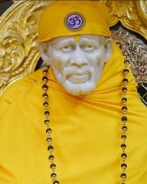 Yellow Color Clothes wear Sai baba in this images temple