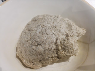 Large portion of dough in the earthenware bowl.