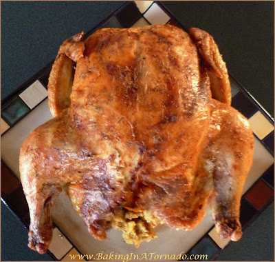 Oven Roasted Whole Chicken, seasoned, basted, and cooked to perfection. As moist and flavorful as a purchased rotisserie chicken at a much lower cost | recipe developed by www.BakingInATornado.com | #recipe #chicken #dinner