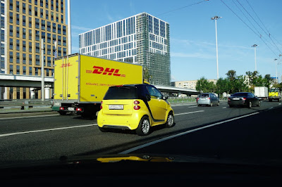 two yellow vehicles on road