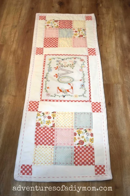 quilted table runner on wood background