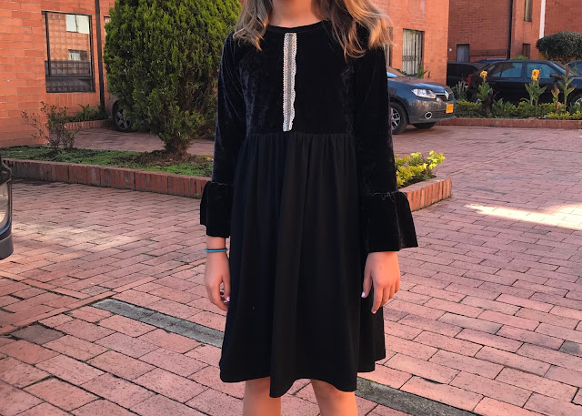 Girls' DIY black velvet bell sleeve dress from a free pattern.