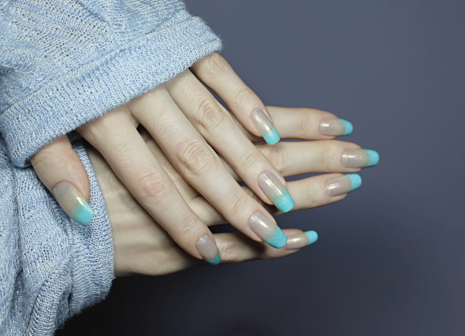 close-up of a hand with long nails and Tiffany Blue gradient nail look