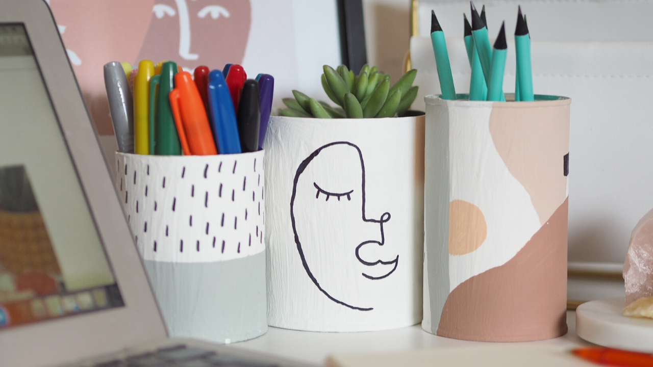 How to make stylish decorated pen pots and plant pots from recycling, rubbish or household trash. Simple budget tutorial making use of items you'll have in your home, and turning them into something beautiful. DIY craft project for a home office. Abstract face designs and rainbow pattern.