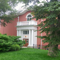 Picture of a red brick building with white portico