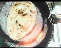 Butter Naan over gas flame