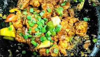 Chilli chicken topped with chopped spring onions
