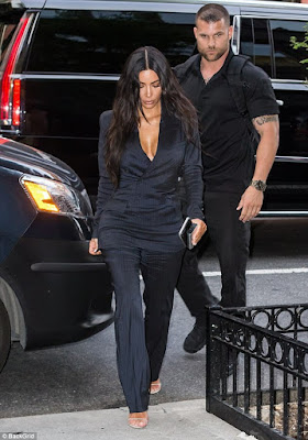 What does Kim Kardashian's bodyguard think he's doing touching her bum?