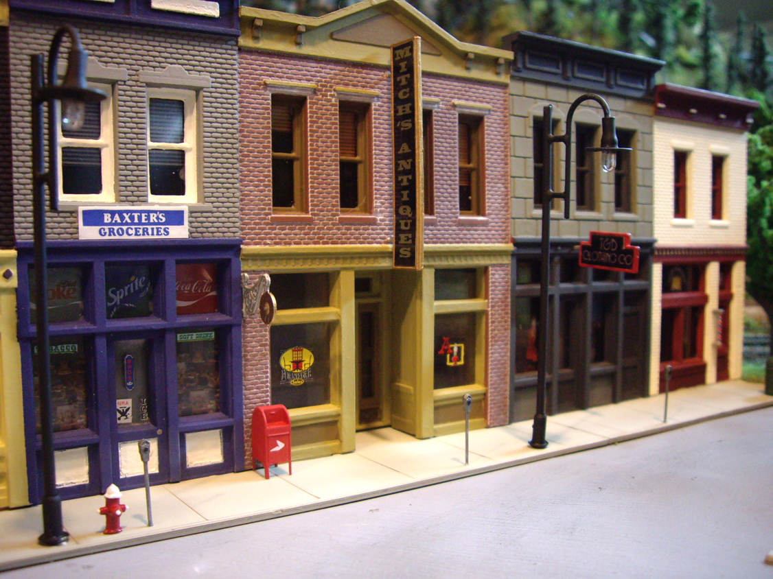 Sidewalk details from Walther’s City Accessories kit including parking meters, fire hydrant and postal box in front of Merchant’s Row