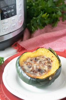 Acorn squash tastes even more fabulous when stuffed with buttery pecans, dates, and brown sugar goodness. Make it even faster with the help of an electric pressure cooker. acorn stuffed with dates, pecans and brown sugar in front of instant pot