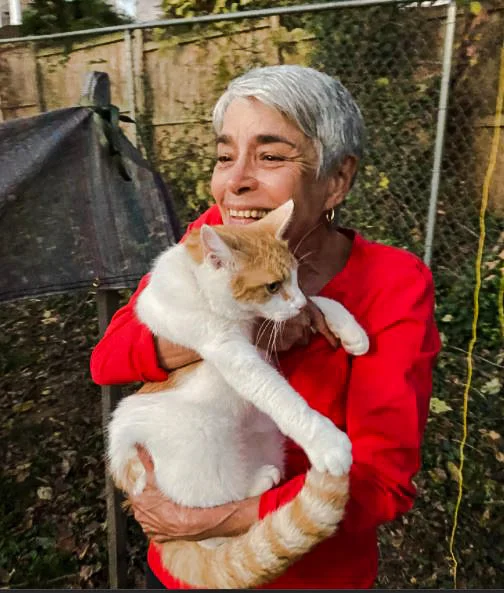Delores Bushong, who lives in Northeast, hugs her cat Hank after he was rescued from a tree in her neighbor's yard. (Courtesy of Humane Rescue Alliance)