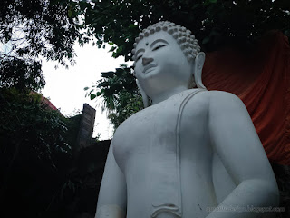 Bottom View Big White Buddha Statue Under The Tree At Buddhist Monastery In Bali Indonesia