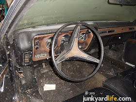 Driver's seat and dash view of 1973 Dodge Charger 440 Rallye parked in storage building at Stinnett's Auto Parts in Alabama on junkyardlife.com